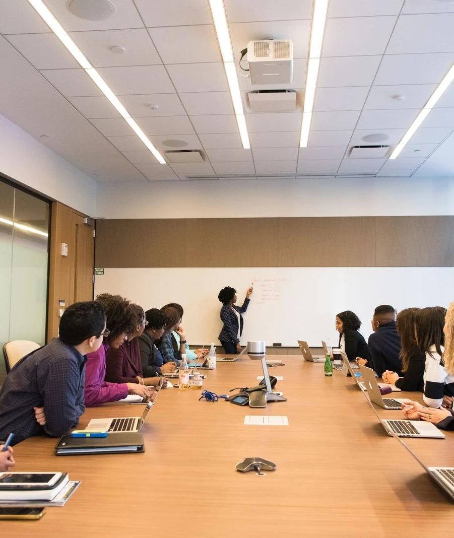 Adults listening to a presentation around a table
